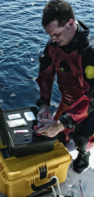 Diver working from an open yellow Pelican Storm case